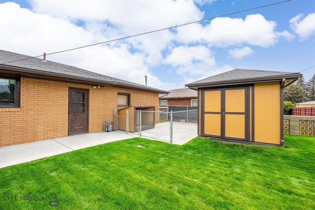 3011 Kossuth, Butte, MT 59701 - back of property with a fenced backyard, a storage shed, a patio area, and brick siding