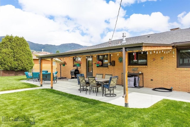 3011 Kossuth, Butte, MT 59701 - back of property with a patio area, brick siding, and a mountain view