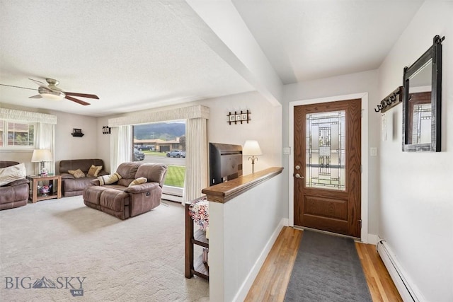 3011 Kossuth, Butte, MT 59701 - entrance foyer featuring a baseboard radiator, ceiling fan, and wood finished floors