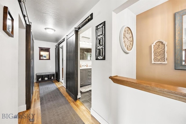 3011 Kossuth, Butte, MT 59701 - hallway featuring a barn door and wood finished floors