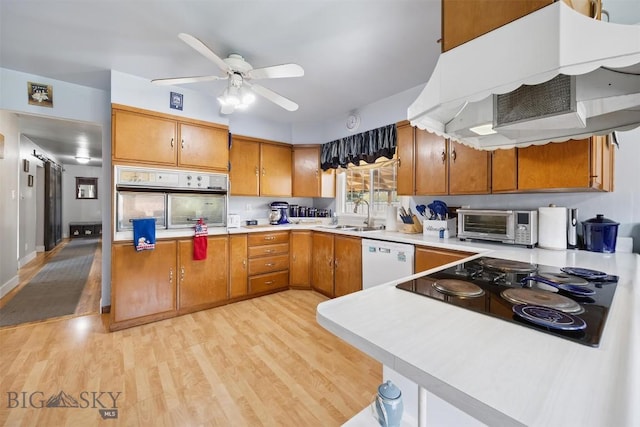 3011 Kossuth, Butte, MT 59701 - kitchen featuring ventilation hood, dishwasher, stainless steel oven, black electric cooktop, and light countertops