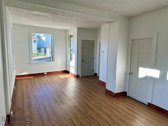 110 E Center St, Butte, MT 59701 - spare room featuring wood finished floors and a textured ceiling