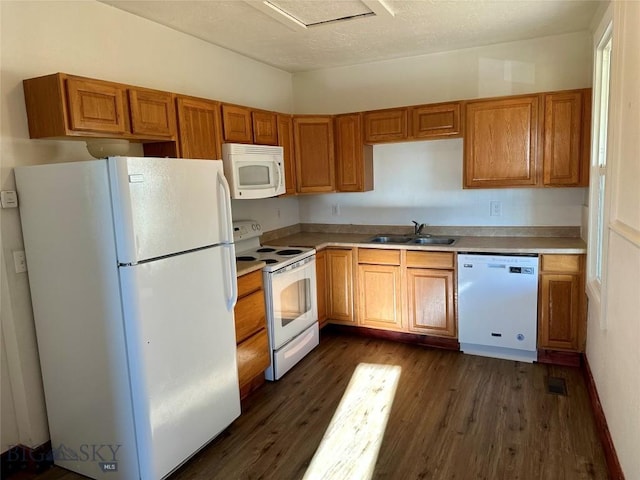 110 E Center St, Butte, MT 59701 - kitchen with white appliances, dark wood-style flooring, light countertops, and brown cabinetry