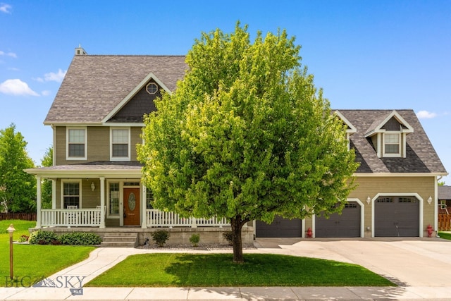 34 W Katina Ct, Bozeman, MT 59718 - view of front of house featuring covered porch, concrete driveway, a front lawn, and roof with shingles