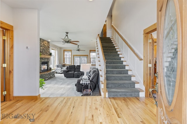 34 W Katina Ct, Bozeman, MT 59718 - foyer entrance with wood finished floors, stairs, a stone fireplace, and a ceiling fan