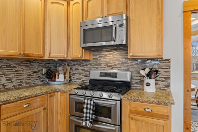 34 W Katina Ct, Bozeman, MT 59718 - kitchen with stainless steel appliances, decorative backsplash, and light stone countertops