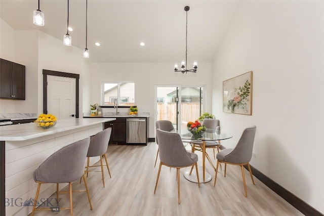 1511 Pistolero Way, Belgrade, MT 59714 - dining area with light wood-style flooring, a chandelier, high vaulted ceiling, and recessed lighting