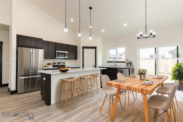 1511 Pistolero Way, Belgrade, MT 59714 - dining room featuring a chandelier, high vaulted ceiling, light wood finished floors, and recessed lighting