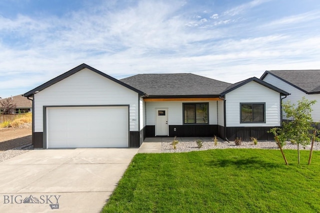 1511 Pistolero Way, Belgrade, MT 59714 - view of front facade with concrete driveway, an attached garage, a front yard, and roof with shingles