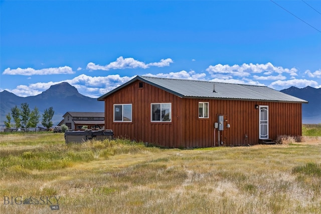 30 Hayfield Loop Trl, Ennis, MT 59729 - view of home's exterior featuring board and batten siding, a mountain view, and a metal roof