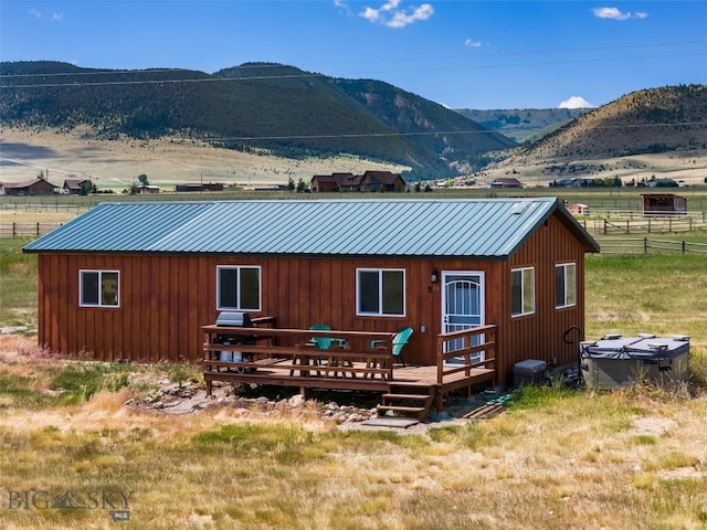30 Hayfield Loop Trl, Ennis, MT 59729 - back of house with a deck with mountain view, a metal roof, and board and batten siding