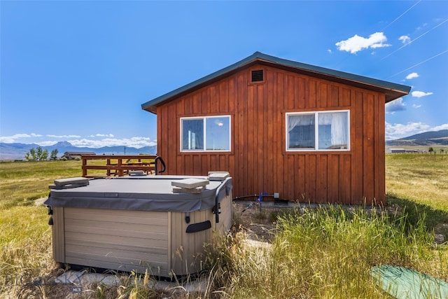 30 Hayfield Loop Trl, Ennis, MT 59729 - view of property exterior featuring a hot tub, a mountain view, and board and batten siding