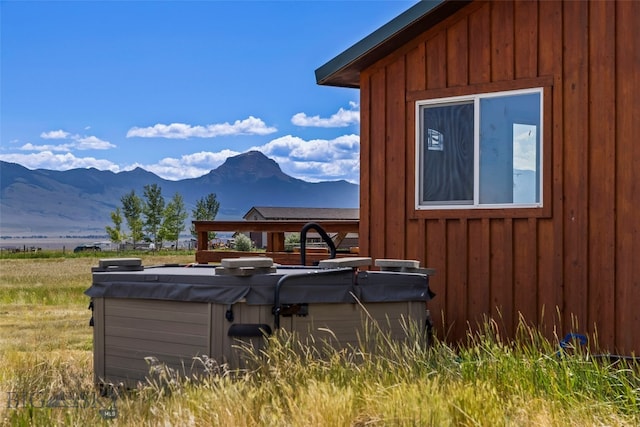 30 Hayfield Loop Trl, Ennis, MT 59729 - view of home's exterior with a hot tub, a mountain view, and board and batten siding