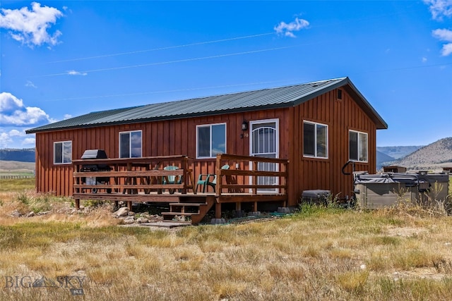 30 Hayfield Loop Trl, Ennis, MT 59729 - back of house featuring board and batten siding, a deck with mountain view, and a metal roof