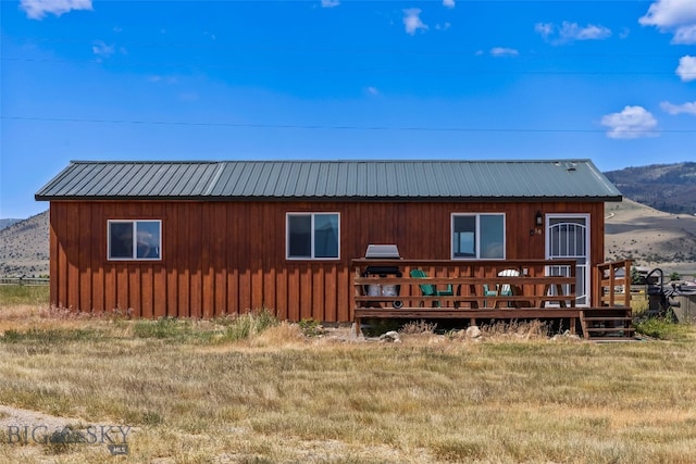 30 Hayfield Loop Trl, Ennis, MT 59729 - rear view of property featuring a metal roof and a deck with mountain view