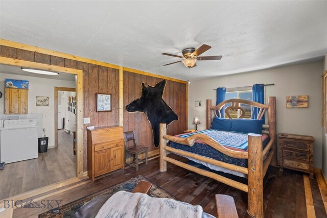 30 Hayfield Loop Trl, Ennis, MT 59729 - bedroom featuring dark wood-type flooring, washing machine and dryer, wooden walls, and a ceiling fan