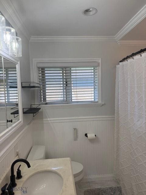 306 Juniper St, Anaconda, MT 59711 - full bath featuring a wainscoted wall, plenty of natural light, vanity, ornamental molding, and a shower with shower curtain