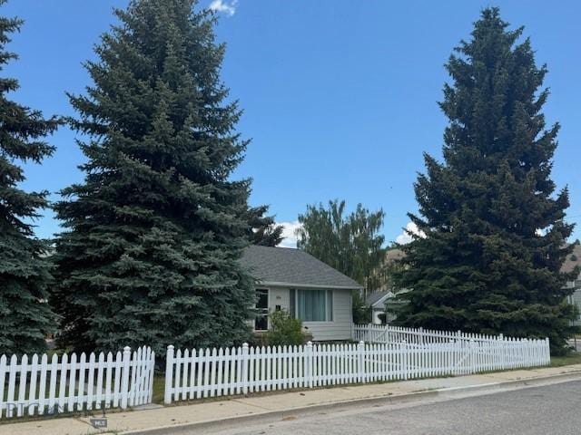 306 Juniper St, Anaconda, MT 59711 - view of property hidden behind natural elements featuring a fenced front yard