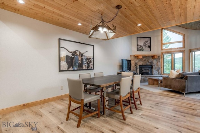 8 Ringneck Dr, Big Sky, MT 59716 - dining room featuring wood ceiling, light wood-style flooring, recessed lighting, vaulted ceiling, and a stone fireplace