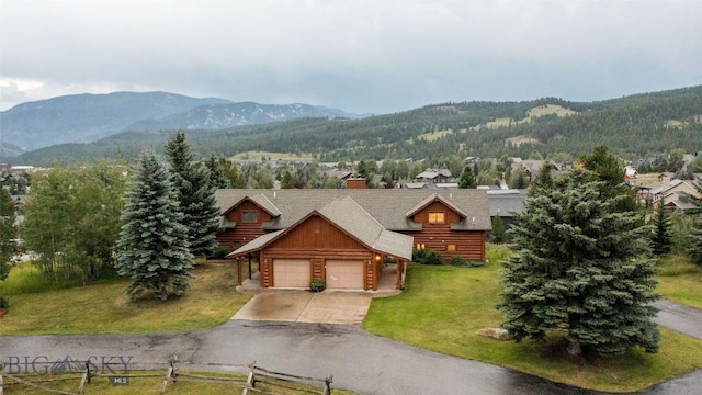 8 Ringneck Dr, Big Sky, MT 59716 - cabin featuring a mountain view, a garage, a front yard, and concrete driveway