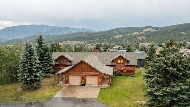8 Ringneck Dr, Big Sky, MT 59716 - view of front of home with a mountain view, a garage, a front lawn, and concrete driveway
