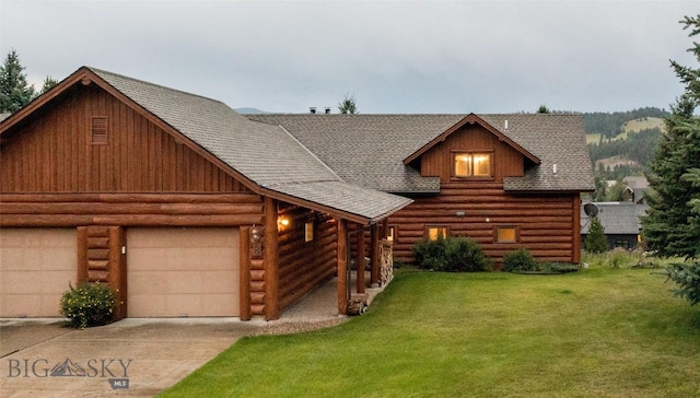 8 Ringneck Dr, Big Sky, MT 59716 - cabin with concrete driveway, roof with shingles, a front yard, log siding, and a garage