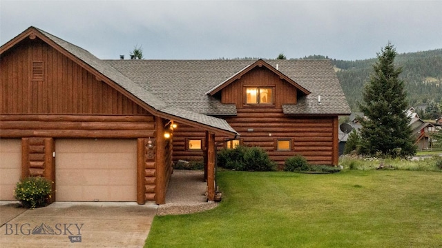 8 Ringneck Dr, Big Sky, MT 59716 - log-style house featuring a shingled roof, concrete driveway, and a front yard