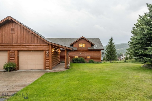 8 Ringneck Dr, Big Sky, MT 59716 - log home featuring a shingled roof, concrete driveway, a front yard, an attached garage, and log exterior