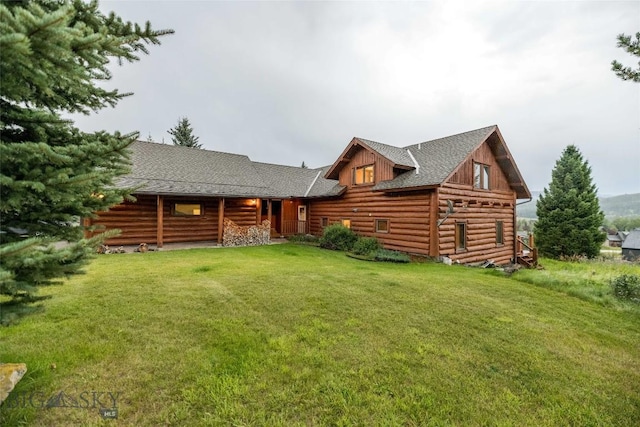 8 Ringneck Dr, Big Sky, MT 59716 - log home with log siding, a front yard, and roof with shingles
