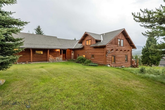8 Ringneck Dr, Big Sky, MT 59716 - view of front of home featuring log exterior, a front lawn, and roof with shingles