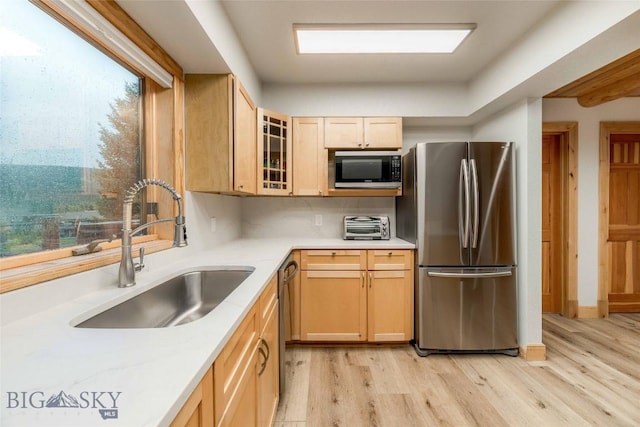 8 Ringneck Dr, Big Sky, MT 59716 - kitchen with stainless steel appliances, light wood-style floors, light brown cabinetry, and light countertops