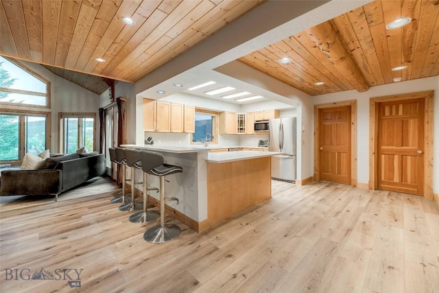 8 Ringneck Dr, Big Sky, MT 59716 - kitchen with stainless steel appliances, wooden ceiling, recessed lighting, a peninsula, and glass insert cabinets