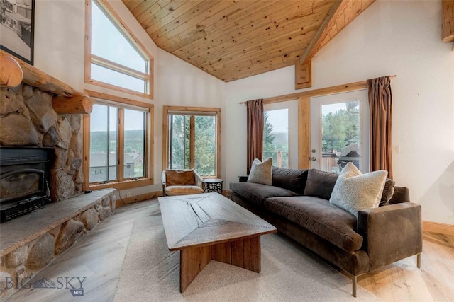 8 Ringneck Dr, Big Sky, MT 59716 - living area with wood finished floors, wood ceiling, a wood stove, healthy amount of natural light, and high vaulted ceiling