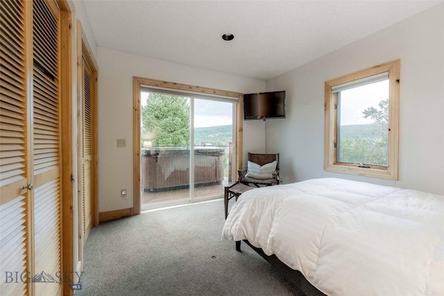 8 Ringneck Dr, Big Sky, MT 59716 - carpeted bedroom featuring access to exterior and baseboards