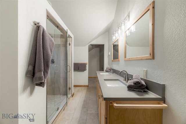 8 Ringneck Dr, Big Sky, MT 59716 - bathroom with double vanity, a stall shower, a textured wall, lofted ceiling, and tile patterned flooring