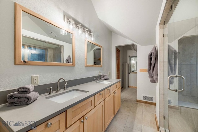 8 Ringneck Dr, Big Sky, MT 59716 - full bath featuring double vanity, lofted ceiling, a stall shower, tile patterned flooring, and a textured wall