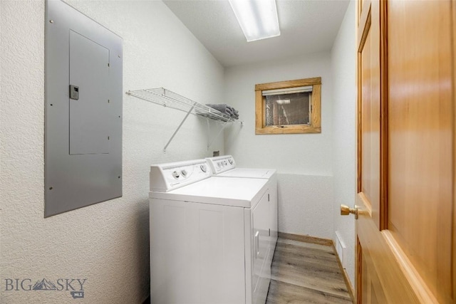 8 Ringneck Dr, Big Sky, MT 59716 - laundry area with electric panel, independent washer and dryer, light wood-style floors, and a textured wall