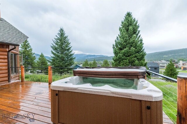 8 Ringneck Dr, Big Sky, MT 59716 - deck with a hot tub and a mountain view