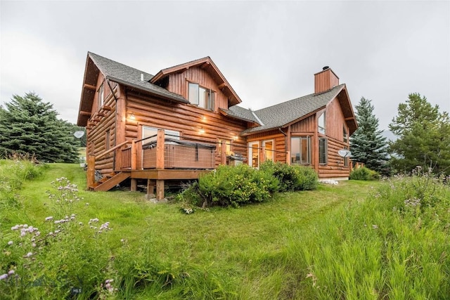 8 Ringneck Dr, Big Sky, MT 59716 - rear view of house with a chimney, a deck, a shingled roof, and log siding