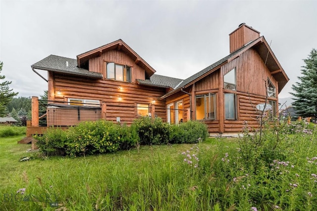8 Ringneck Dr, Big Sky, MT 59716 - rear view of property with log exterior, a chimney, and roof with shingles