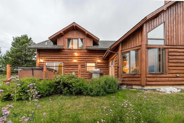 8 Ringneck Dr, Big Sky, MT 59716 - rear view of house with a shingled roof, log siding, and a lawn