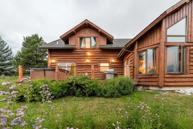8 Ringneck Dr, Big Sky, MT 59716 - rear view of property with a shingled roof, a lawn, and log siding