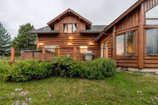8 Ringneck Dr, Big Sky, MT 59716 - back of house featuring roof with shingles, a lawn, and log siding