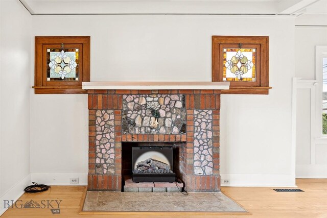 1039 Placer St, Butte, MT 59701 - detailed view of wood finished floors and a brick fireplace