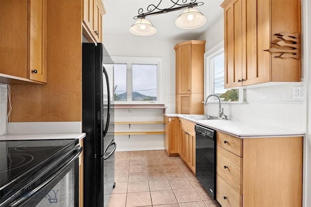 1039 Placer St, Butte, MT 59701 - kitchen featuring black appliances, light countertops, light brown cabinetry, and light tile patterned floors