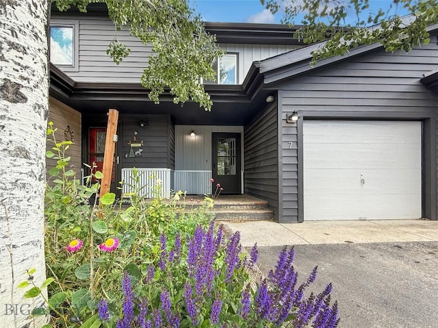80 Aspen Leaf Dr Unit 7, Big Sky, MT 59716 - property entrance with an attached garage, a porch, and asphalt driveway