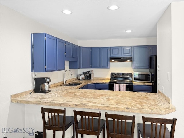 80 Aspen Leaf Dr Unit 7, Big Sky, MT 59716 - kitchen with black appliances, under cabinet range hood, blue cabinets, a peninsula, and light countertops