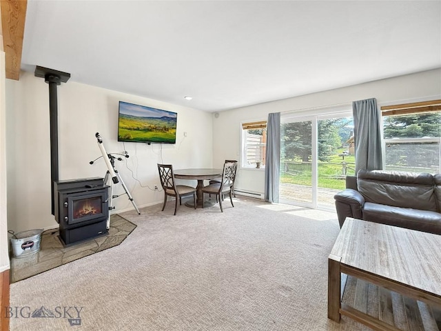 80 Aspen Leaf Dr Unit 7, Big Sky, MT 59716 - carpeted living room with a wood stove and a baseboard heating unit