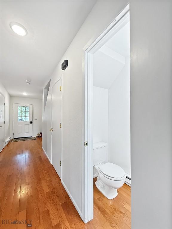 80 Aspen Leaf Dr Unit 7, Big Sky, MT 59716 - corridor featuring light wood-style flooring and a baseboard heating unit
