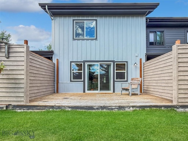 80 Aspen Leaf Dr Unit 7, Big Sky, MT 59716 - rear view of house with a wooden deck, a yard, and board and batten siding